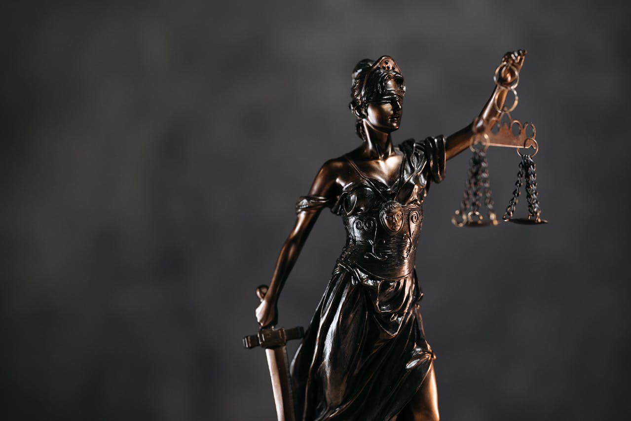 Lady Justice statue symbolizing legal consequences of business disputes